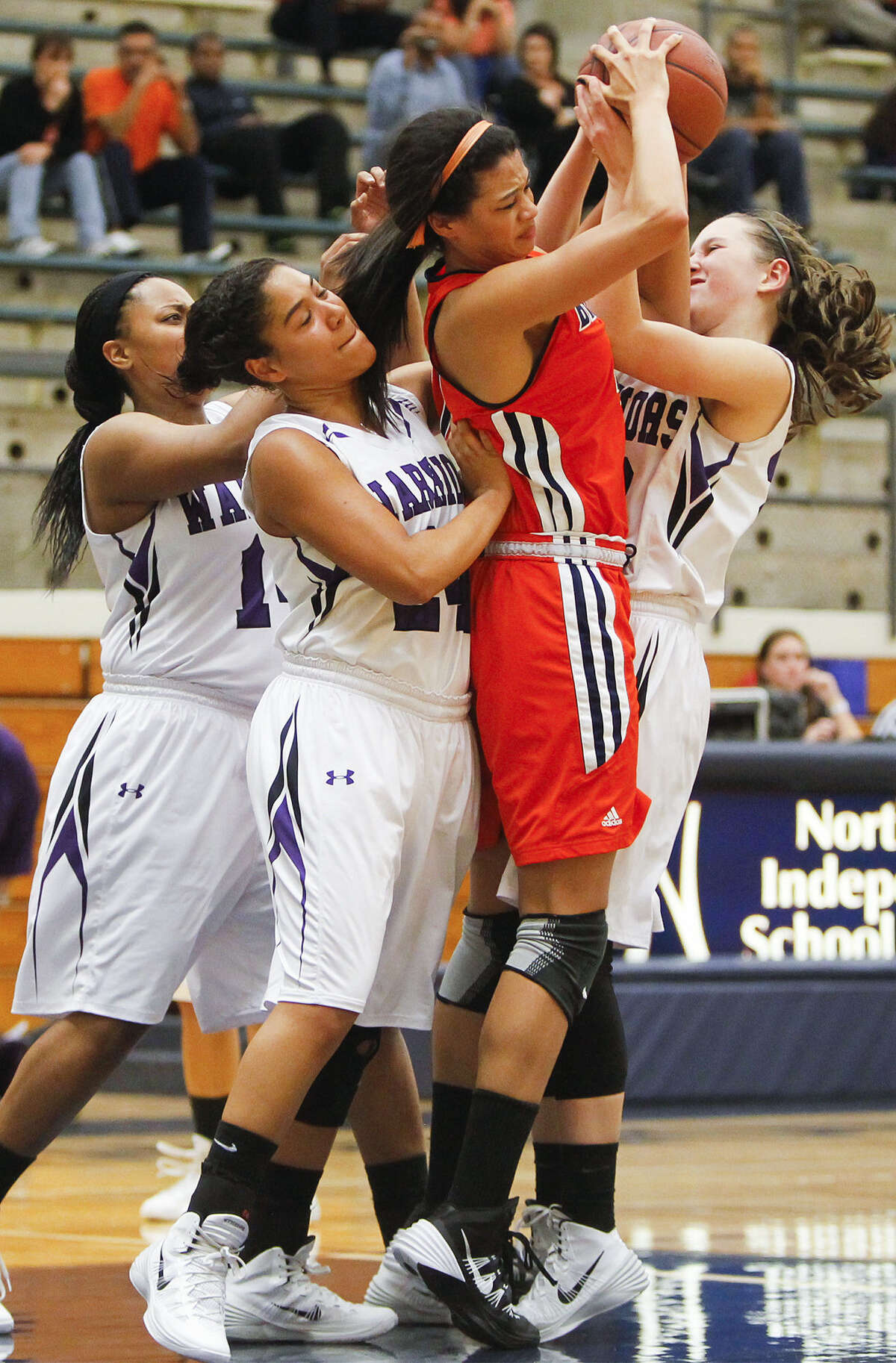 Brandeis' Morgan Williams, second from right, fights for a rebound with Warren's Adrienne Lightfoot, left, Lauryn Elliot and Victoria Hall during the first half of their Dec. 4 game.