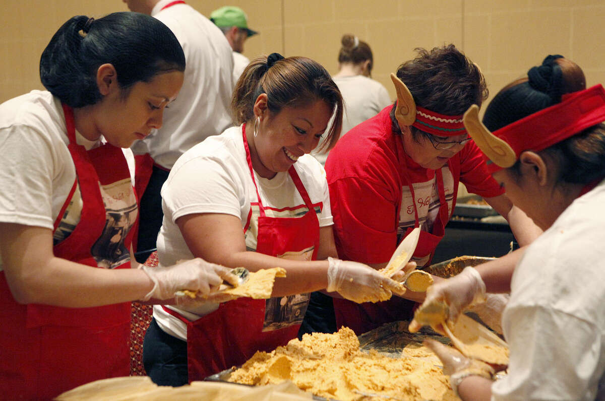 From left: Dania Contreas, Norma Ramos and Paula Ramos from the Alamo Plaza Marriott location compete in a tamale making competition Tuesday, Dec. 17, 2013 at the JW Marriott San Antonio HIll Country Resort and Spa during the Tamalathon. A team made up of tables had to make 180 tamales to win and the ones that won did so in a little under 18 minutes.