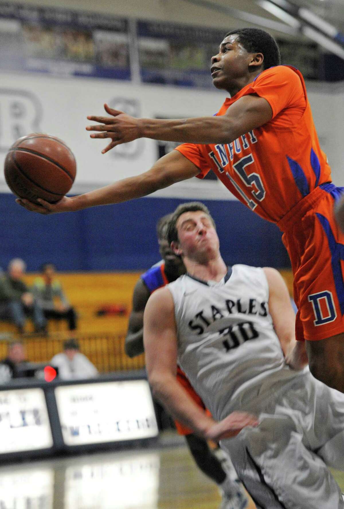 Danbury high school's Tysheen McCrea driving to the basket during a boys basketball game against Staples high school played at Staples, Westport, CT on Wednesday, December,18th, 2013.