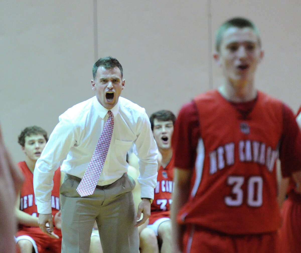 At left, New Canaan High School boys basketball head coach Mike Evans screams during the boys varsity basketball game between Greenwich High School and New Canaan High School at Greenwich, Wednesday night, Dec. 18, 2013.