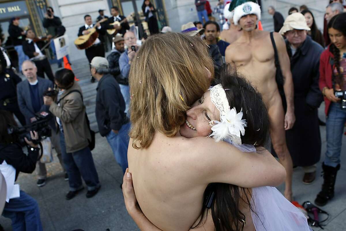 Gypsy Taub and Jaymz Smith share a hug after being married in the nude on the steps of City Hall in San Francisco, CA, Thursday, December 19, 2013. Nudity activist Gypsy Taub gets married naked to her fiance Jaymz Smith on the steps of San Francisco City Hall.