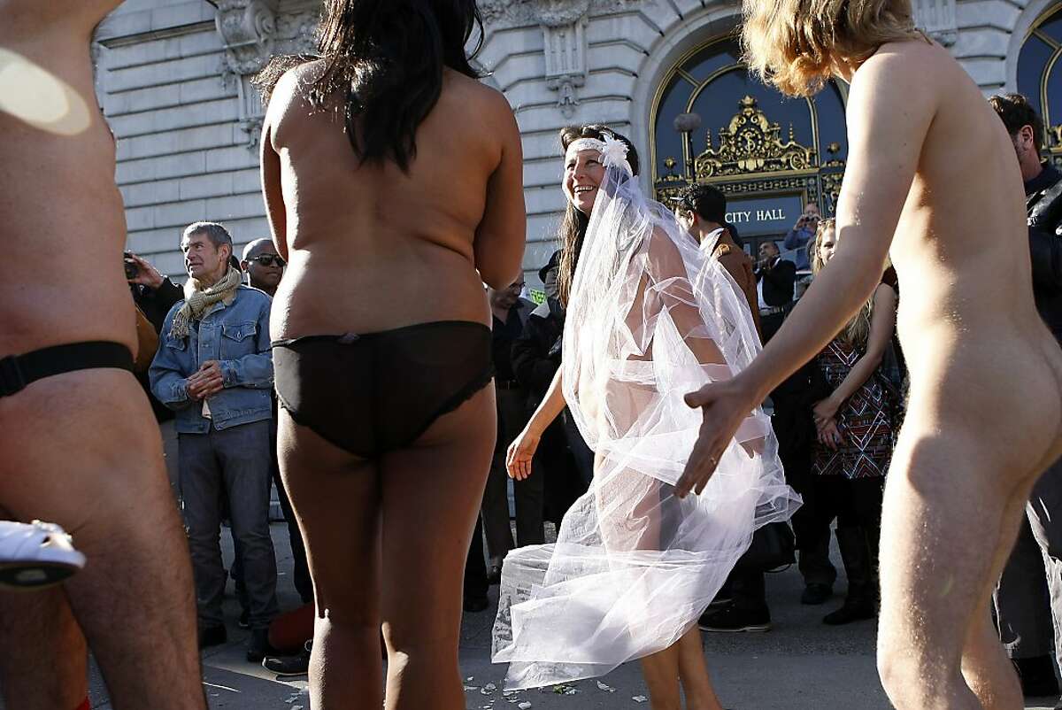 Gypsy Taub, 2nd from right, dance with friends after her nude wedding in fr...