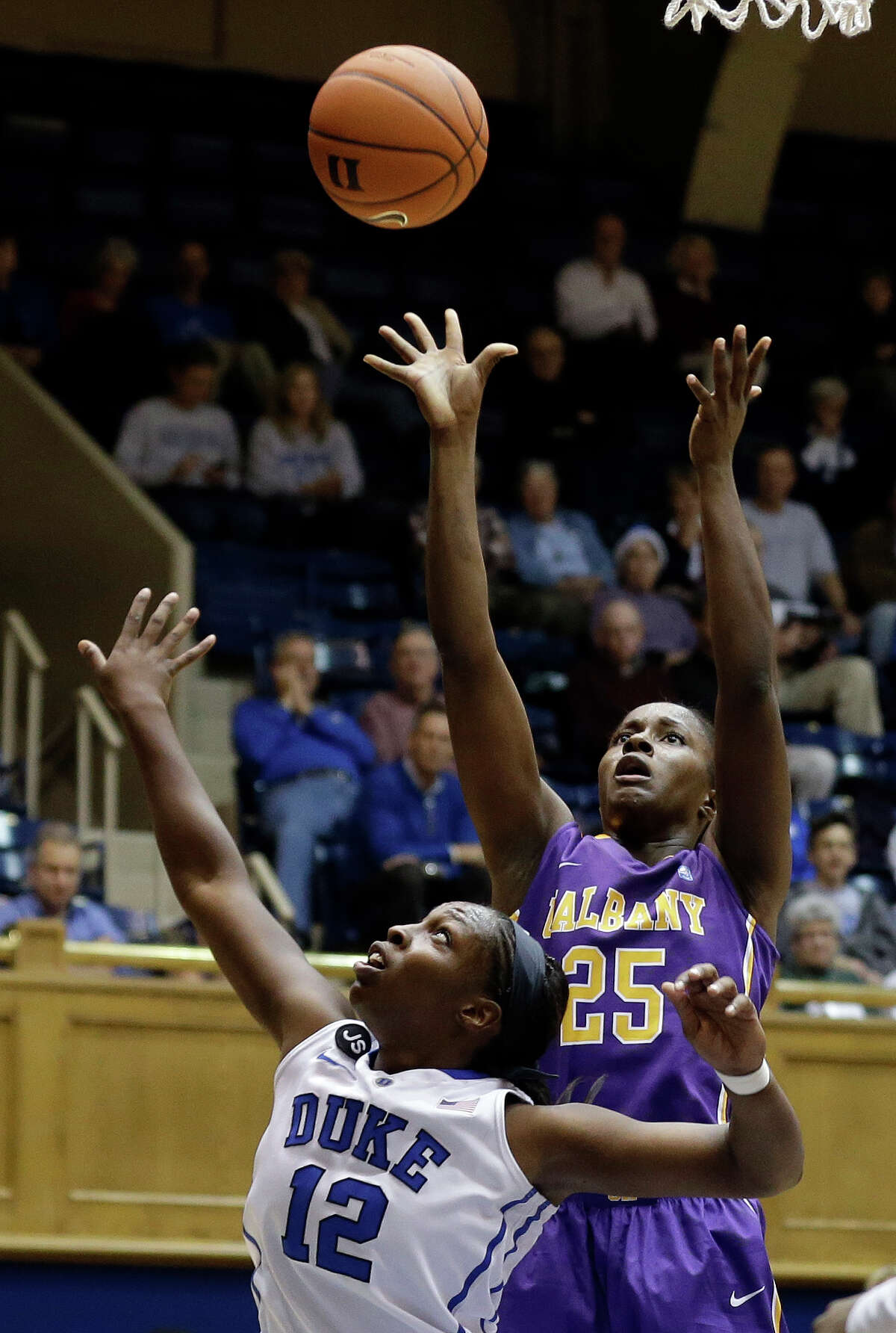 Duke's Chelsea Gray (12) defends as Albany's Shereesha Richards (25) shoots during the second half of an NCAA college basketball game in Durham, N.C., Thursday, Dec. 19, 2013. Duke won 80-51. (AP Photo/Gerry Broome) ORG XMIT: NCGB106