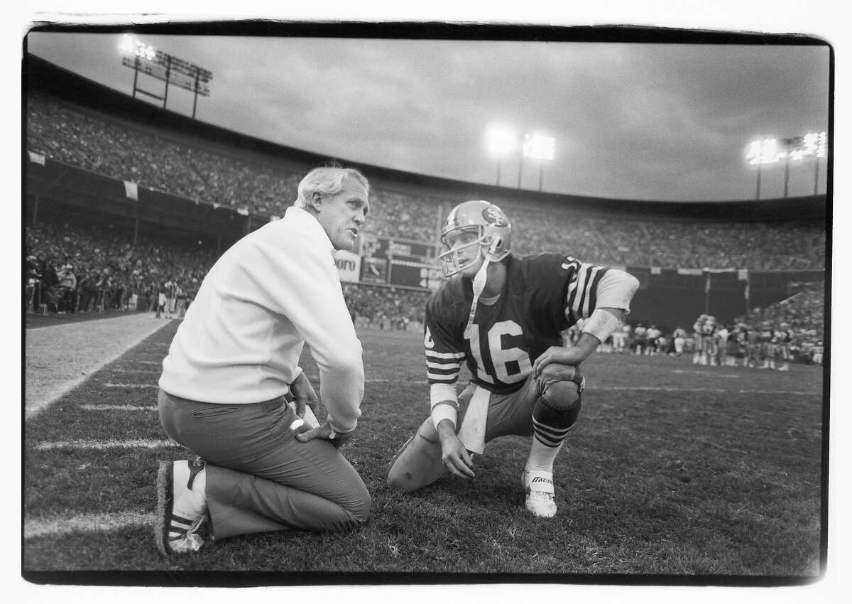 SAN FRANCISCO - JANUARY 6: Head coach Bill Walsh of the San Francisco 49ers talks to quarterback Joe Montana #16 during the 1984 NFC Championship Game against the Chicago Bears at Candlestick Park on January 6, 1985 in San Francisco, California. The Niners defeated the Bears 23-0. (Photo by Michael Zagaris/Getty Images)