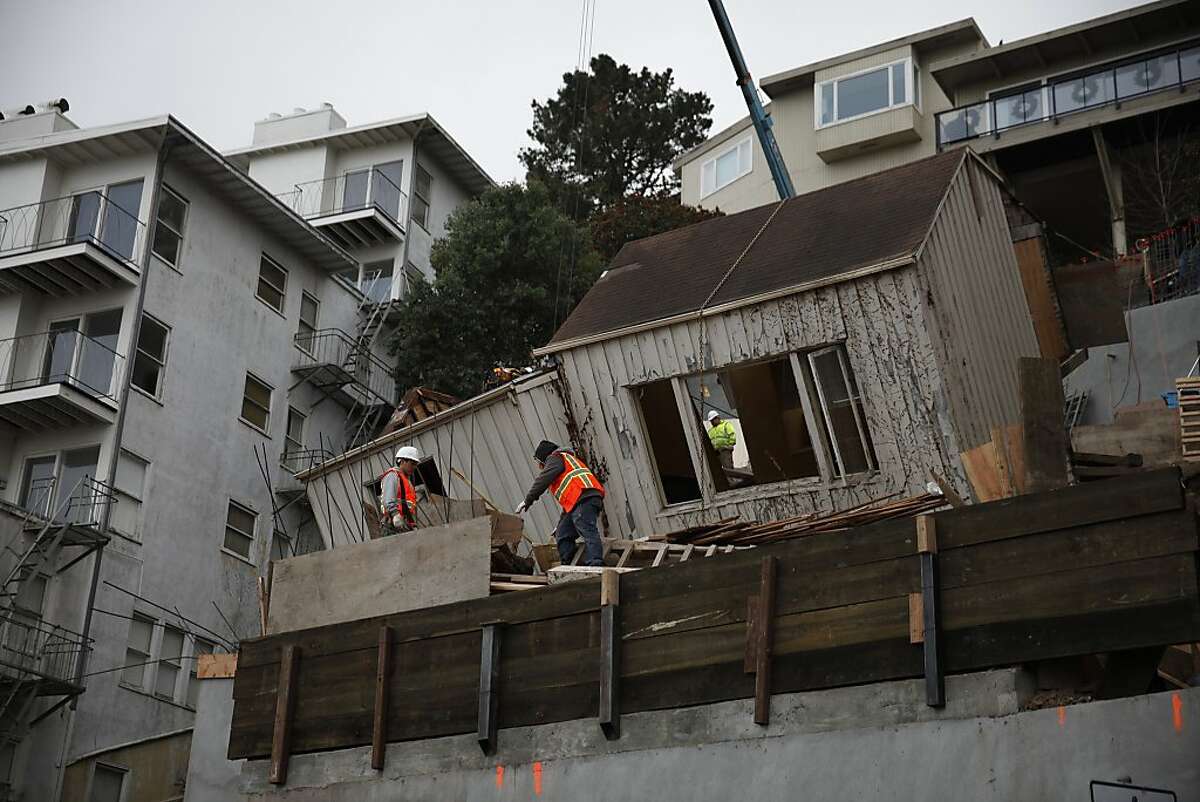 Laborers are seen working at 125 Crown Terrance on Wednesday, December 18, 2013 in San Francisco, Calif.