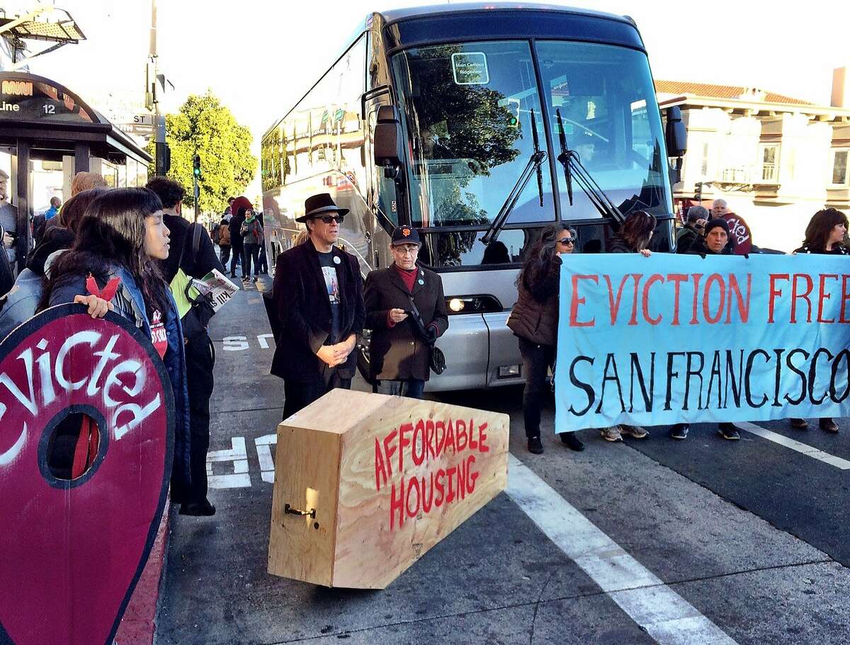 Anti-gentrification protesters temporarily block a shuttle bus full of tech workers on Dec. 20, 2013, in San Francisco's Mission District.