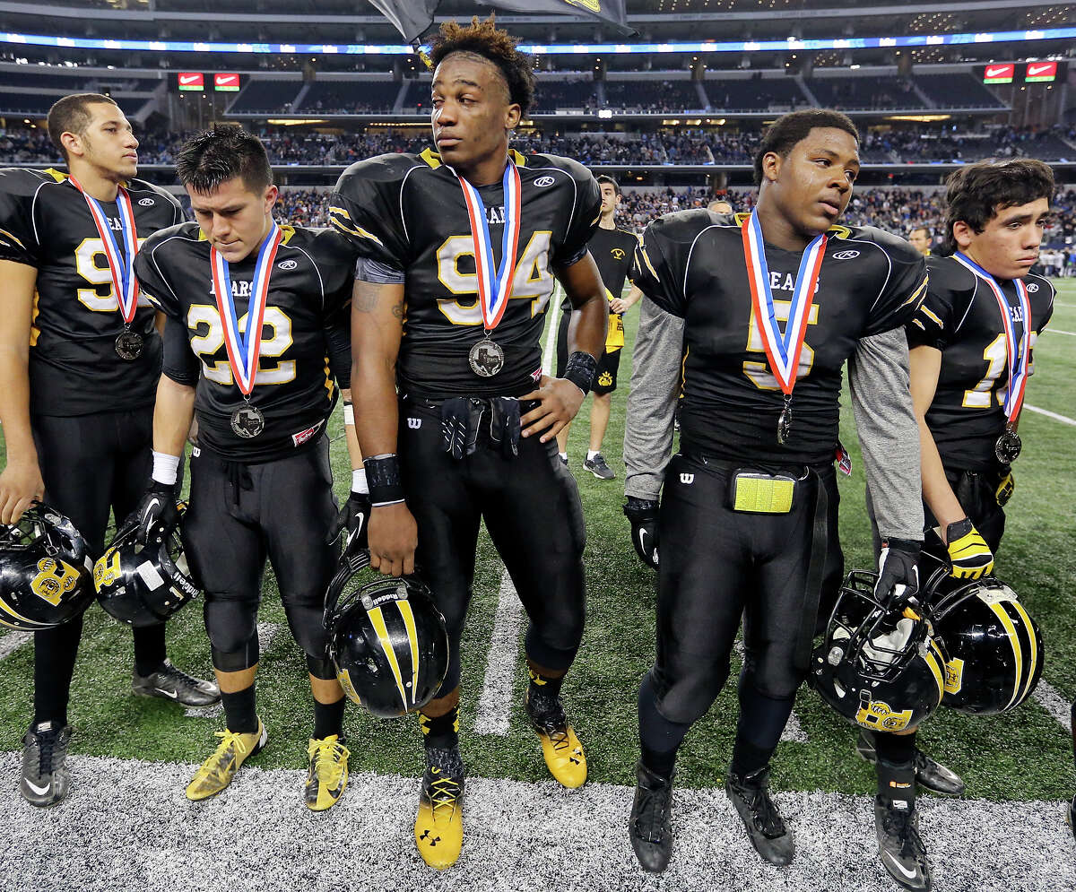 Members of the Brennan Bears react after their Class 4A Division I state championship game with Denton Guyer Friday Dec. 20, 2013 at AT&T Stadium in Arlington, Tx. Denton Guyer won 31-14.