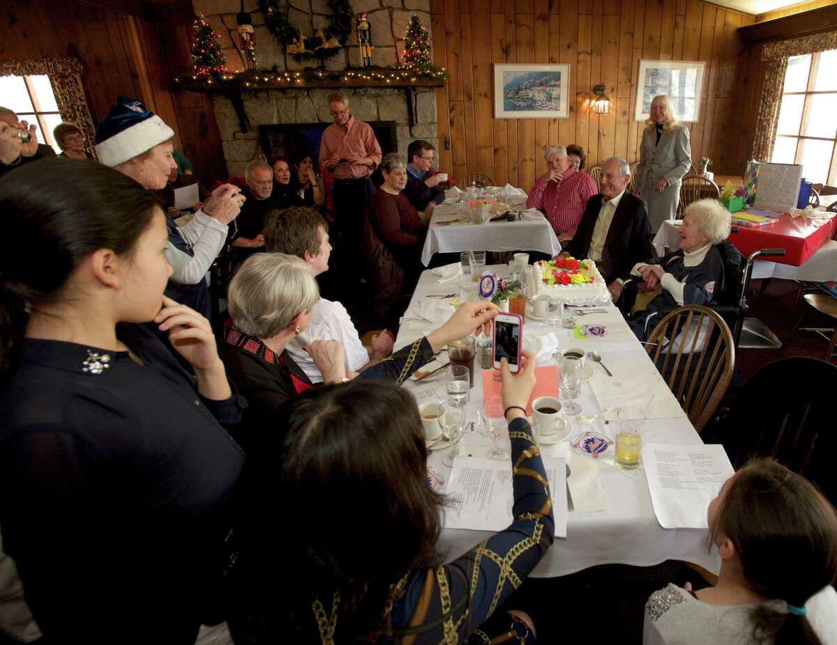 Friends and family gather around Dorothy Juliette Sokollow, as she celebrates her 100th birthday with a baseball themed party at The Hearth Restaurant, in Brookfield Conn, on Saturday, December 21, 2013. Juliette's birthdate is December 27, 1913.