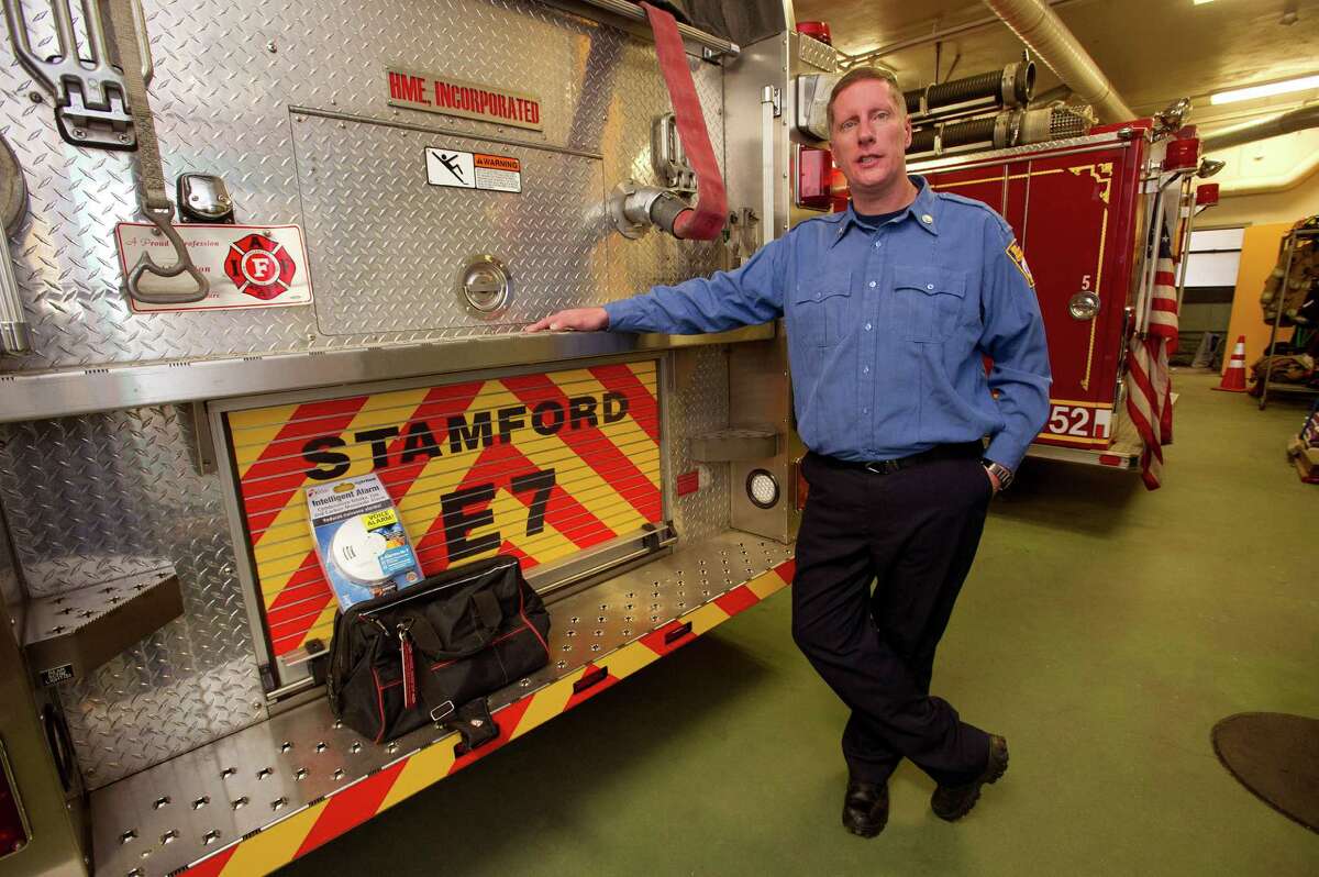 Capt. Victor Rella stands with a smoke and carbon monoxide alarm installation kit at Springdale Fire Company on Friday, December 20, 2013. The station keeps the kits on hand and uses them at homes where they find owners are without the alarms.