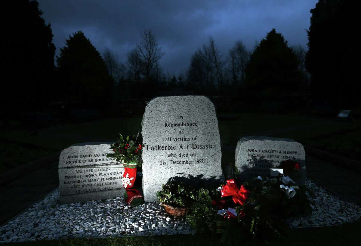 Floral tributes are seen near the main memorial stone in memory of the victims of Pan Am flight 103 bombing in the garden of remembrance at Dryfesdale Cemetery, near Lockerbie, Scotland, Saturday, Dec. 21, 2013. Pan Am flight 103 was blown apart above the Scottish border town of Lockerbie on Dec. 21, 1988. All 269 passengers and crew on the flight and 11 people on the ground were killed in the bombing. (AP Photo/Scott Heppell).