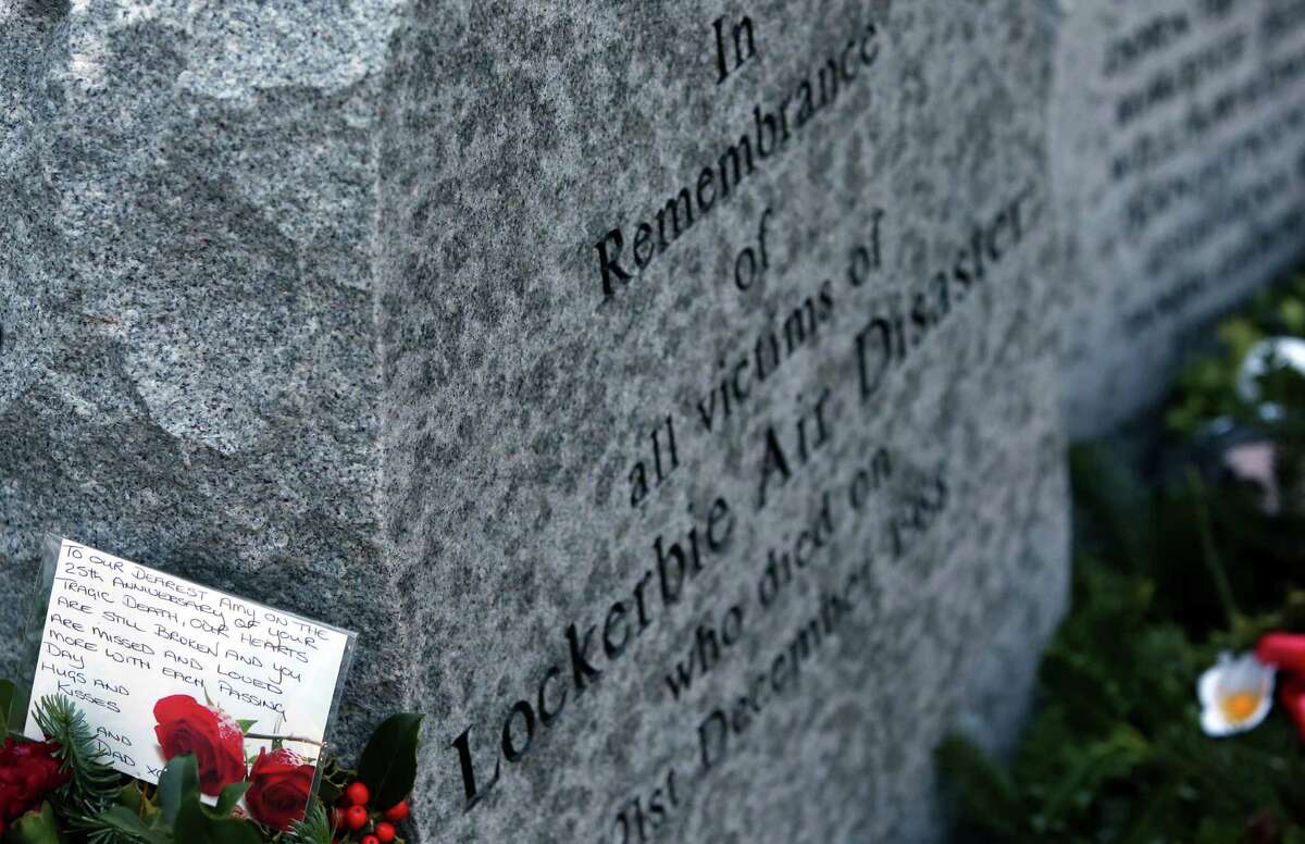 A handwritten card is seen on a wreath laid by the main memorial stone, in memory of a victim of the Pan Am flight 103 bombing, in the garden of remembrance at Dryfesdale Cemetery, near Lockerbie, Scotland. Saturday Dec. 21, 2013. Pan Am flight 103 was blown apart above the Scottish border town of Lockerbie on Dec. 21, 1988. All 269 passengers and crew on the flight and 11 people on the ground were killed in the bombing. (AP Photo/Scott Heppell).