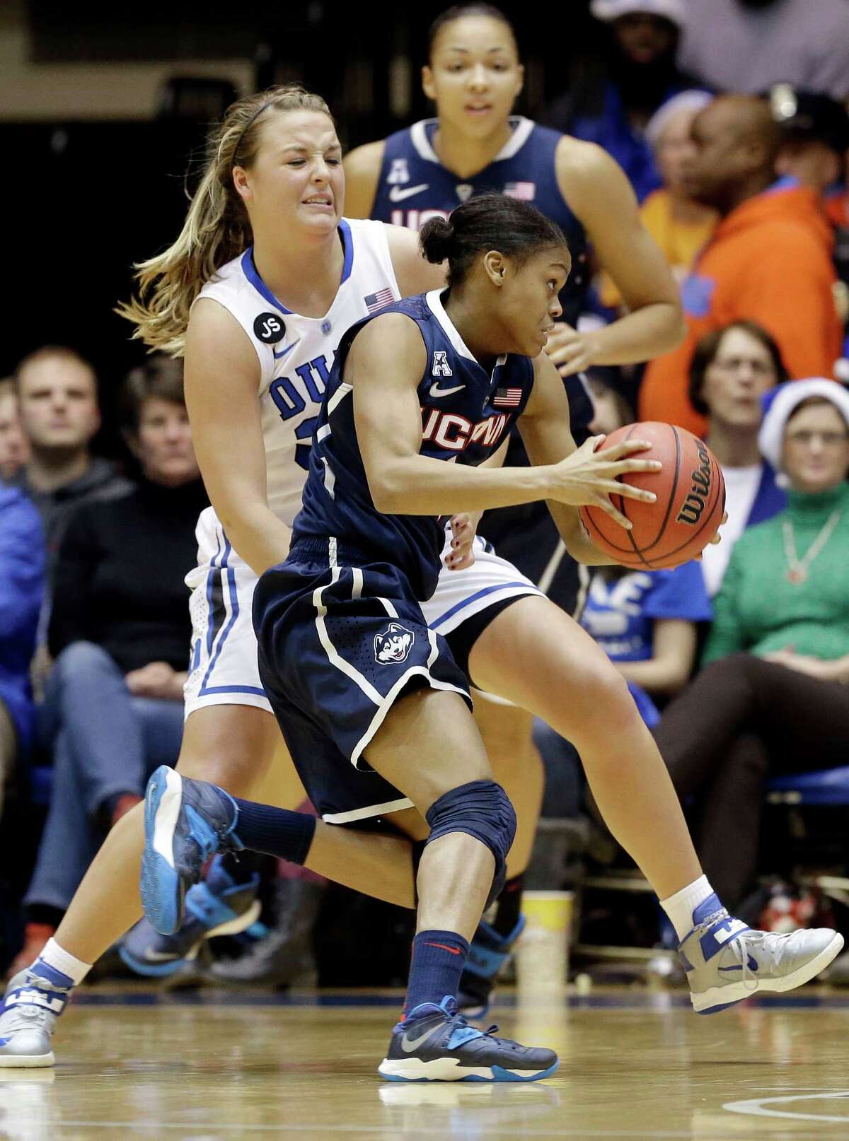 Connecticut's Moriah Jefferson is guarded by Duke's Tricia Liston, rear, during the first half of an NCAA college basketball game in Durham, N.C., Tuesday, Dec. 17, 2013. (AP Photo/Gerry Broome)