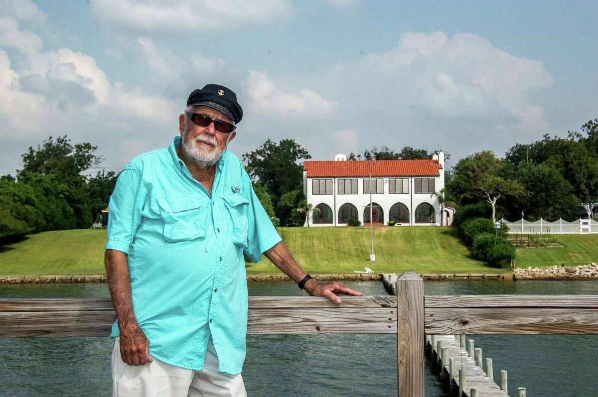 Dick Wright stands atop a decking built on a pier jutting out into Galveston Bay from the back of his Morgan's Point 1920's era house, in La Porte, Texas.
