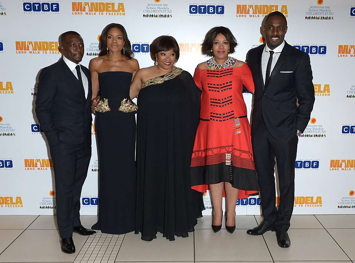 From left to right, Tony Kgoroge, Naomie Harris, Zindzi Mandela, her sister Zenani, and Idris Elba pose for photographers at the UK Premiere of 'Mandela: Long Walk To Freedom' at the Odeon Leicester Square in London on Thursday Dec. 5, 2013. (Photo by Jon Furniss/Invision/AP Images)