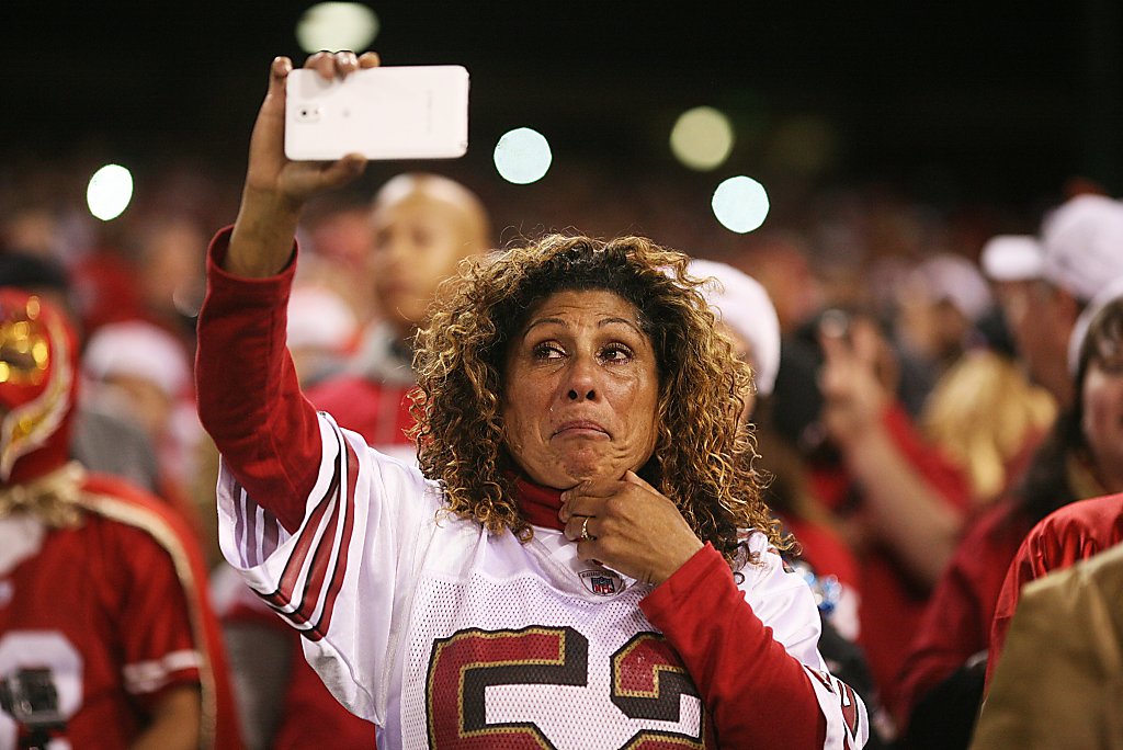 Tailgating fans celebrate in the parking lot before the San Francisco 49ers  play the Atlanta Falcons at Candlestick Park in San Francisco on December  23, 2013. Today is the final regular season