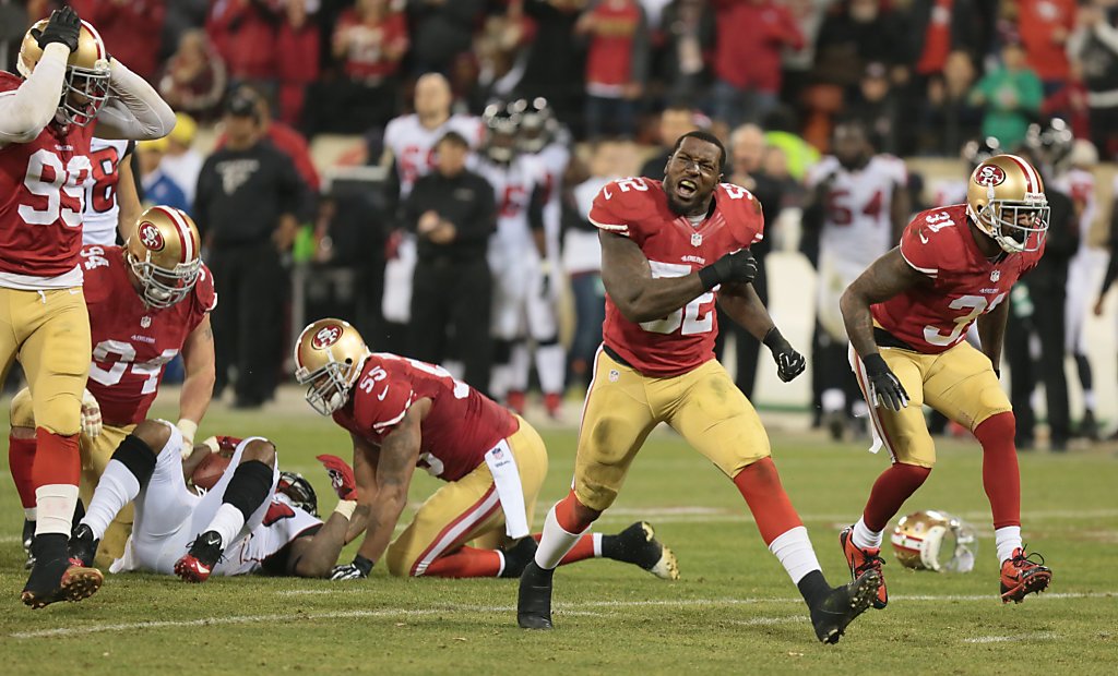 San Francisco 49ers' Terrell Owens (81) evades being tackled by