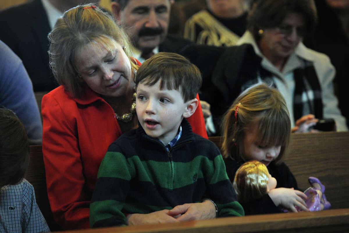 Rita Glynn, of New Canaan, attends Christmas Day Mass with her son Niall, 7, and daughter Phoebe, 4, at Saint Aloysius Church, in New Canaan, Conn. Dec. 25, 2013.