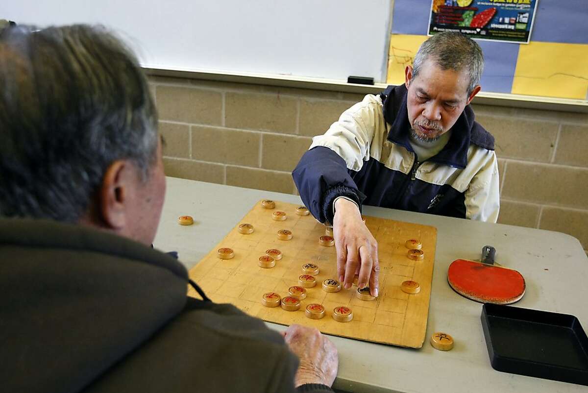 Kai Tsui, right, plays Chinese Checkers with Chen Gumhua in the Art Room at the Minnie and Lovie Ward Recreation Center in the Oceanview district of San Francisco, CA, Wednesday, December 18, 2013.