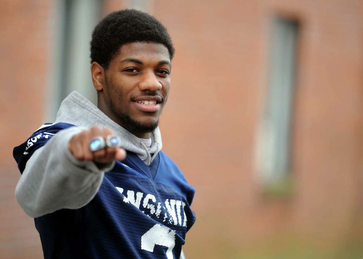 Ansonia High School football player Arkeel Newsome, the all-time rushing leader in the state with more than 10,000 yards, poses for a photograph in downtown Ansonia, Conn. Saturday, Dec. 21, 2013