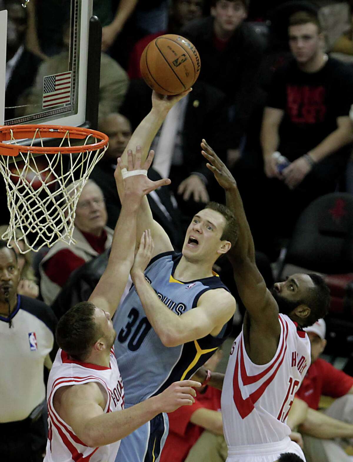The Rockets' Donatas Motiejunas, left, and James Harden double up on the Grizzlies' Jon Leuer (30) in the second half Thursday night.