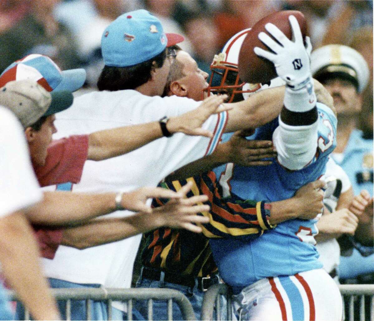 Running back Gary Brown (33) celebrates with fans in the end zone seats after scoring the Oilers' last touchdown in an October victory over Cincinnati at the Astrodome.