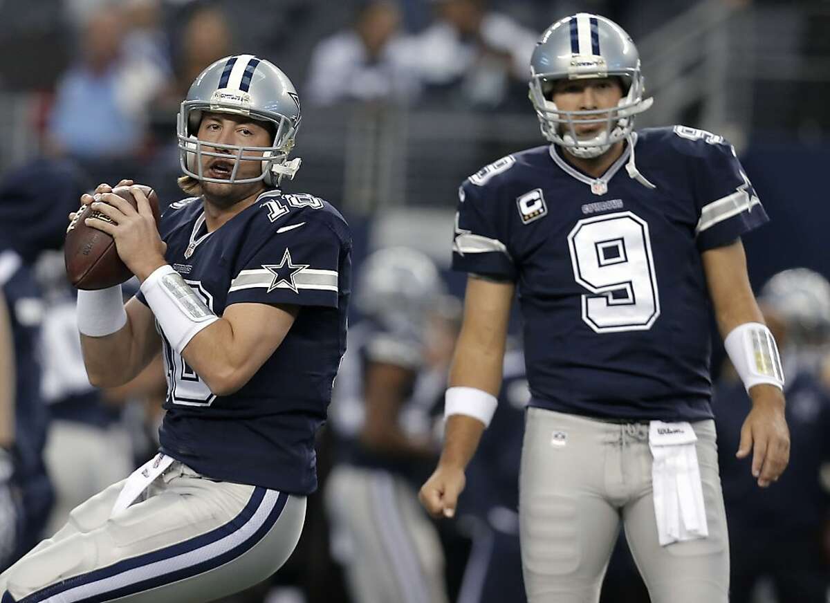 In this Nov. 28, 2013, photo, Dallas Cowboys quarterbacks Kyle Orton (18) and Tony Romo (9) warm up for an NFL football game against the Oakland Raiders in Arlington, Texas. Orton will make his first start at quarterback in his two seasons with the Cowboys on Sunday night, Dec. 29, unless Romo can recover from a herniated disc. Dallas will be playing a winner-take-all game at home against the Philadelphia Eagles for the NFC East title and a playoff berth. (AP Photo/Brandon Wade)