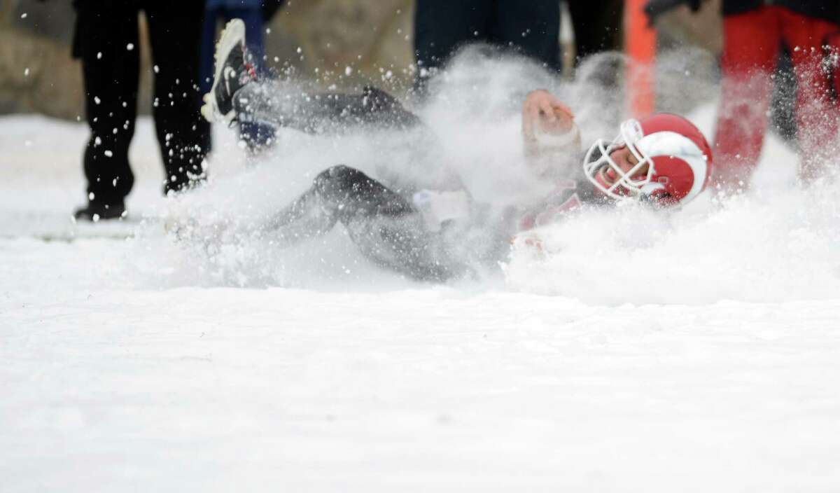 New Canaan's Nick Cascione slides into the endzone during the Class L state championship game against Darien on Saturday, Dec. 14, 2013 at Boyle Stadium in Stamford, Conn.