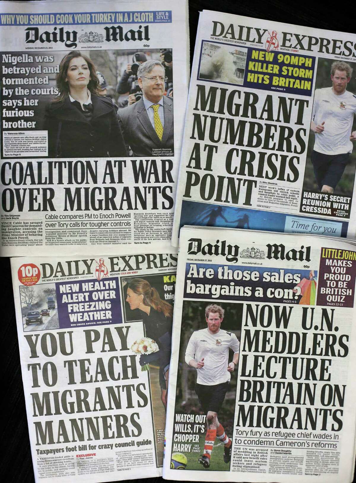 Recent editions of Britain's Daily Express and Daily Mail newspapers, featuring headlines about immigration, are photographed in London, Friday, Dec. 27, 2013. For months, Britain's tabloids have repeatedly warned of the horrors they believe will ensue after Jan. 1, 2014 when work restrictions will be lifted across the European Union for migrants from Romania and Bulgaria â?” two of the trading bloc's newest members. Those changes, the papers claim, will unleash a mass exodus of the poor and unemployed from the two eastern European countries to Britain. (AP Photo/Alastair Grant)