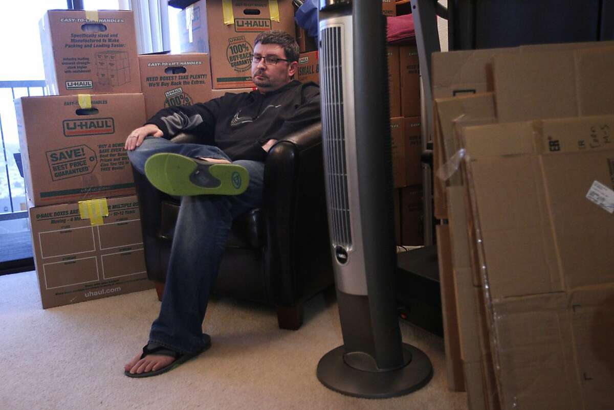 Todd Morgan discusses the difficult decision of moving out of the city while sitting in his living room surrounded by moving boxes December 18, 2013 at his and his wife's apartment in San Francisco, Calif. After four years in their apartment, the landlord decided to raise the rent by $200 and only gave 30 days notice. The two are moving to Alameda, where the cost of living is more affordable.