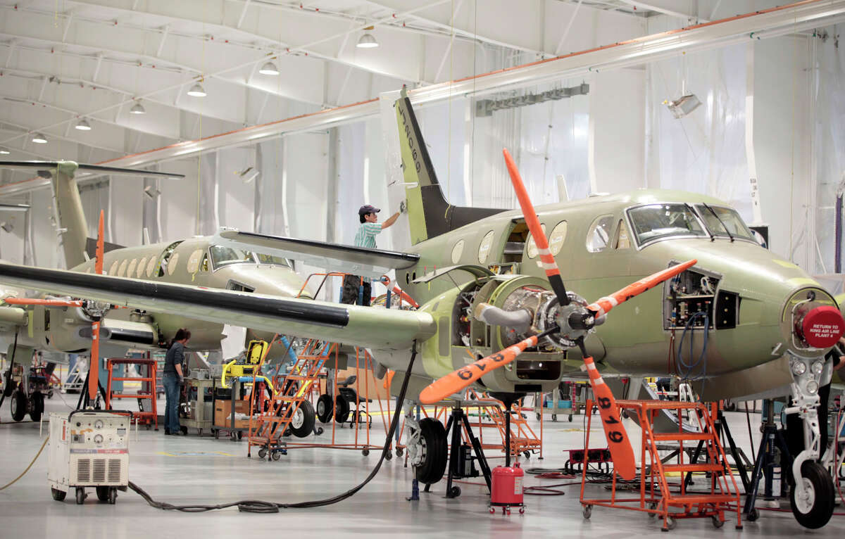 Employees work on the assembly line at Beechcraft in Wichita, Kan., earlier this year. Textron, the parent company of Cessna Aircraft, is buying Beechcraft Corp.