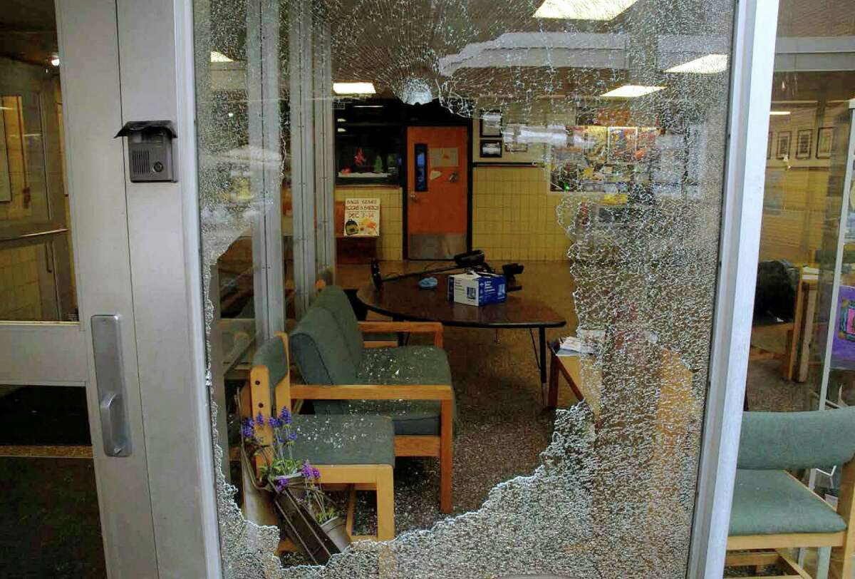 This December 2012 photo released by the Connecticut State Police on Friday, Dec. 27, 2013, shows a shattered window at Sandy Hook Elementary School in Newtown, Conn. Adam Lanza gunned down 20 first-graders and six educators with a semi-automatic rifle at the school on Dec. 14, 2012, after killing his mother inside their home. Lanza committed suicide with a handgun as police arrived at the school. (AP Photo/Connecticut State Police) ORG XMIT: BX151