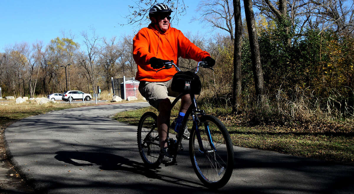 A cyclist rolls along the trail on the Salado Creek Greenway, one of the many linear parks in San Antonio. Officials hope the 45-mile system will almost double and eventually surround the city.