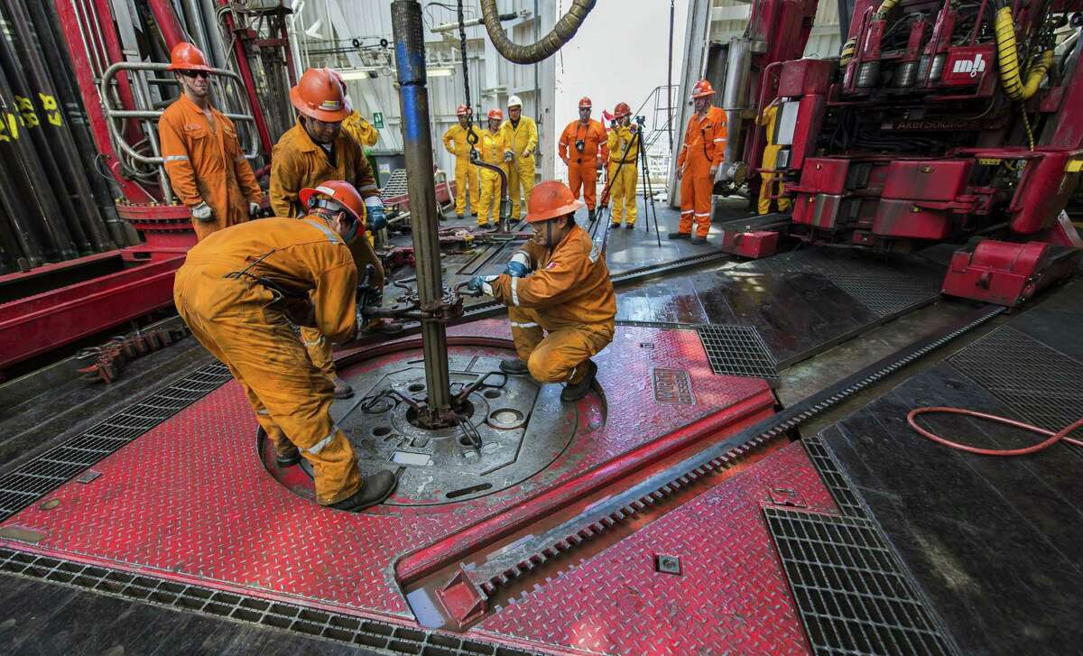 Derrick hands remove a drilling tool that has a sample of the seabed at La Muralla IV oil rig, which was working this summer for Mexico's state-owned company, Pemex, in the Gulf of Mexico.