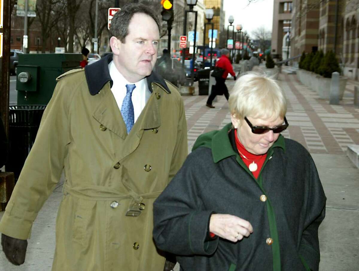 David Grudberg, attorney for Douglas Perlitz, leads Cheryl Perlitz, Douglas Perlitz's mother, into the Federal Courthouse in New Haven, Tuesday, Feb. 2, 2010. Douglas Perlitz, a Fairfield University graduate, is accused of sexually abusing Haitian boys who his charity supposedly was helping.