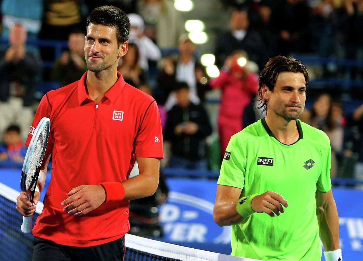 Novak Djokovic, left, dispatched David Ferrer in straight sets to win the World Tennis Championship title and finish the year with a 24-match winning streak on the ATP tour.