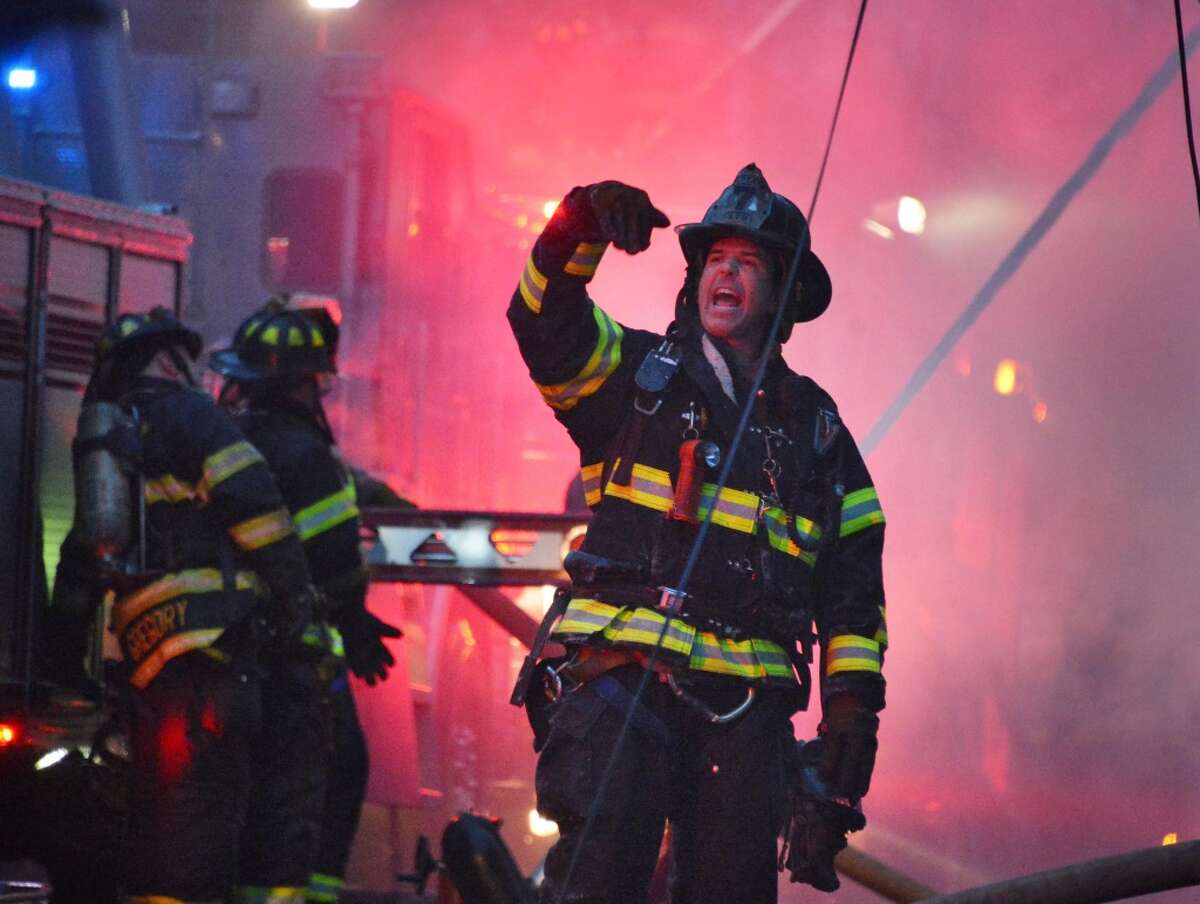 An Albany firefighter calls out orders as they battle a blaze at 159 Dove Street in Albany Friday Jan. 25, 2013. (John Carl D'Annibale / Times Union)