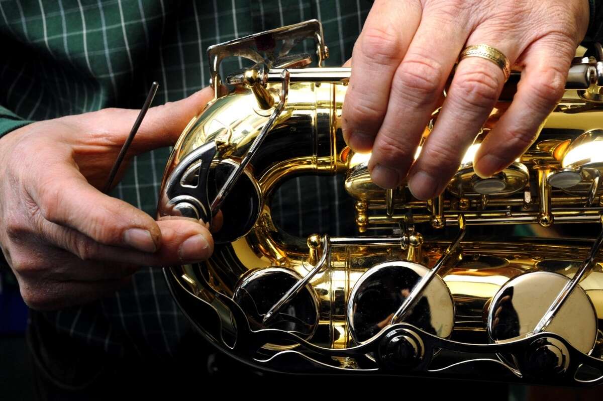 Bill Cole works on a Yamaha alto saxophone checking for air leaks at Cole's Woodwind Shop on Thursday March 21, 2013 in Saratoga Springs, N.Y. (Michael P. Farrell/Times Union)