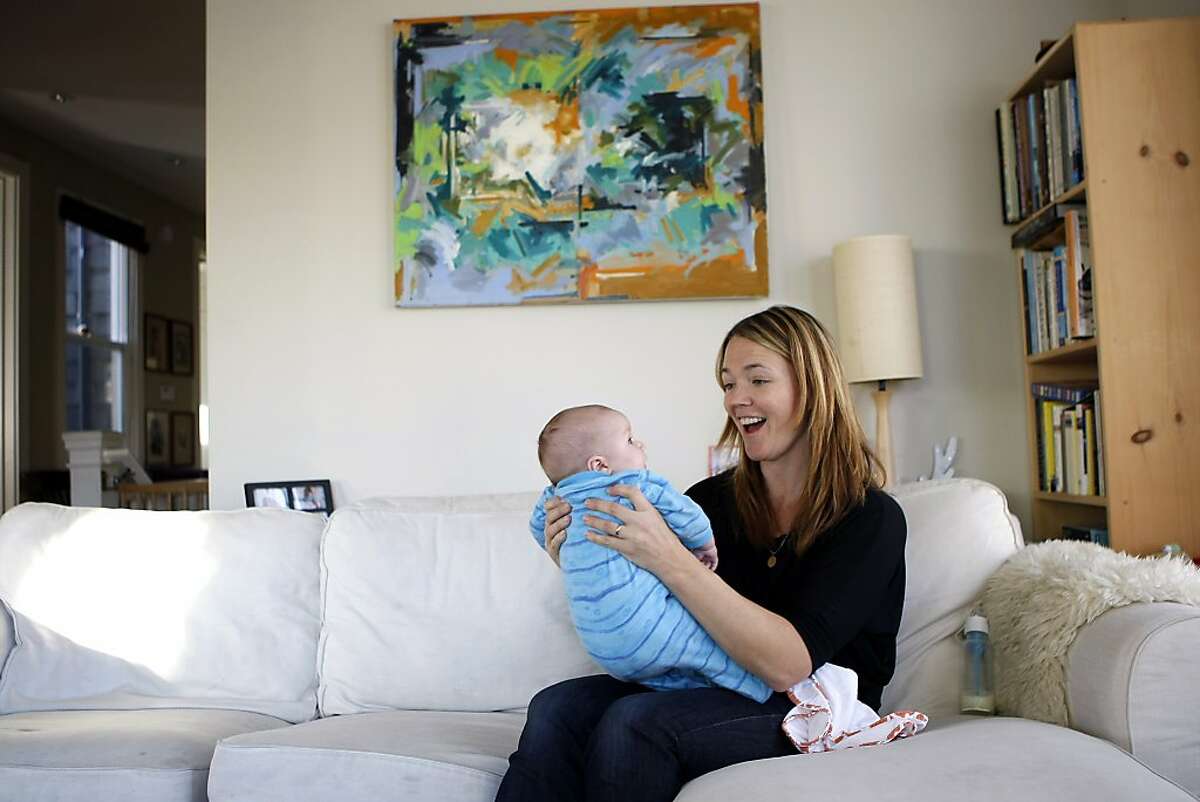 Elizabeth Longstreth holds her 2 month old son Ty French after feeding him formula from a bottle at their home in San Francisco, CA, Sunday, December 22, 2013. Elizabeth feeds her son her own breast milk, but also uses formula and donated breast milk from other women and says she tries to keep up to date with the latest scientific advice for moms regarding feeding.