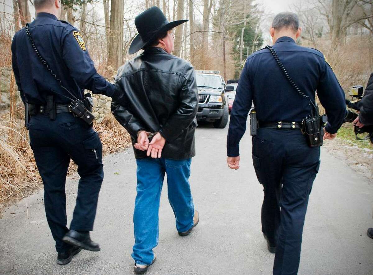 Scott Merrell, former Norwalk mayoral candidate, is taken away in handcuffs by Norwalk police as he is evicted from his house at 6 Woodland Road in Rowayton, Conn. on Tuesday, Feb. 2, 2010.