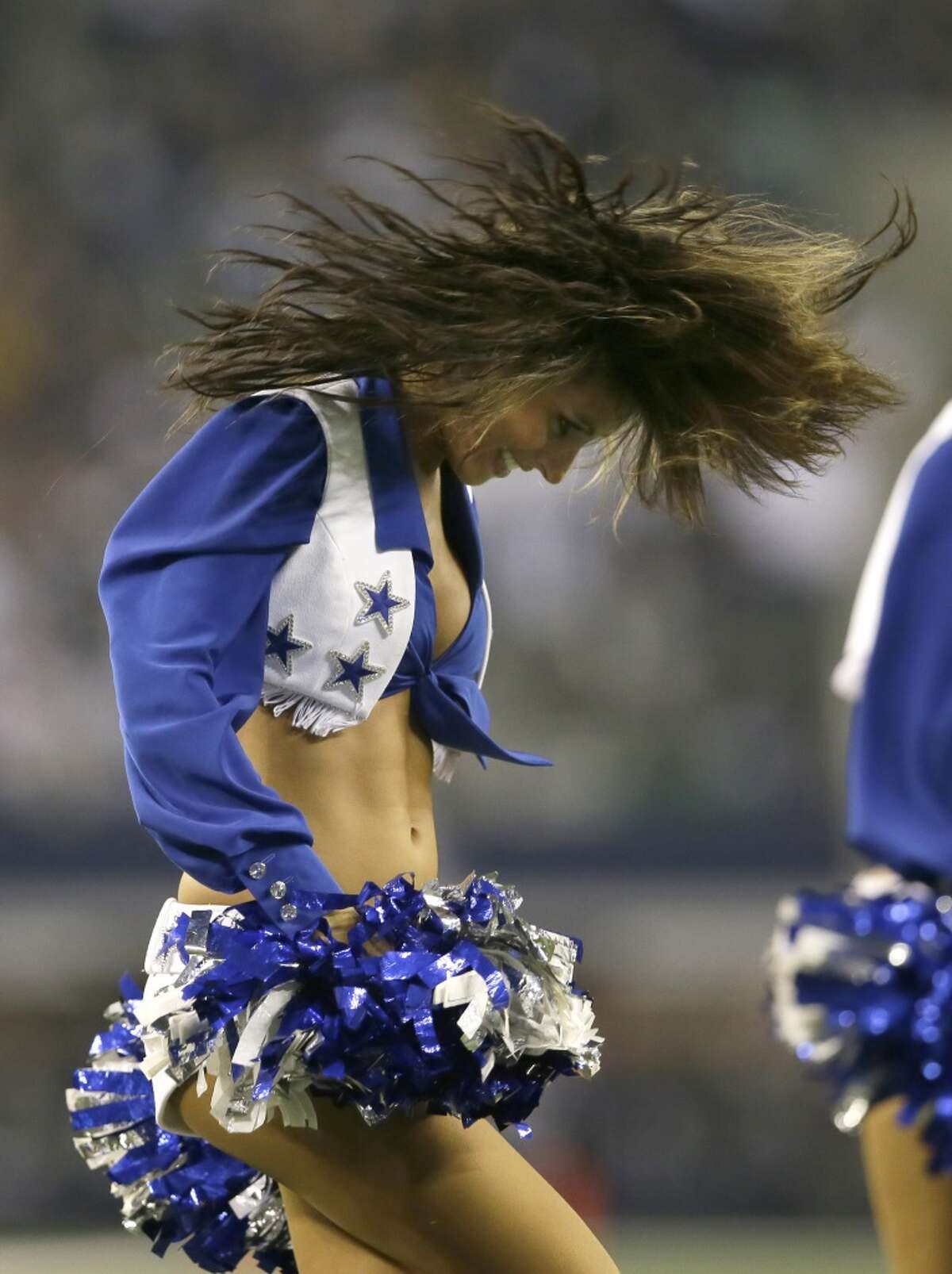 Dallas Cowboys cheerleader dance during the second half of an NFL football game against the Philadelphia Eagles Sunday, Dec. 29, 2013, in Arlington, Texas.