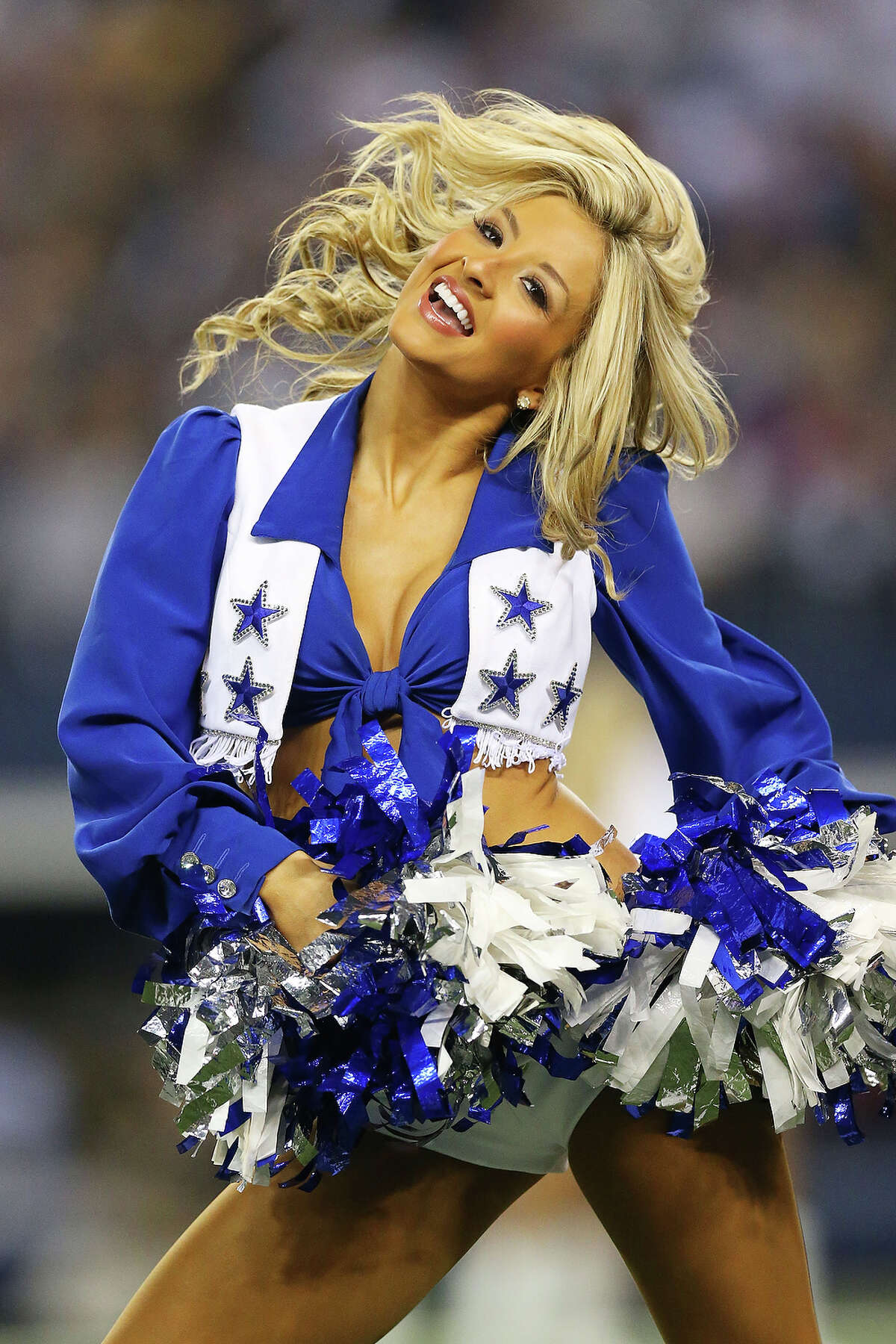 A Dallas Cowboys cheerleader performs during their game against the Philadelphia Eagles at Cowboys Stadium on December 29, 2013 in Arlington, Texas.