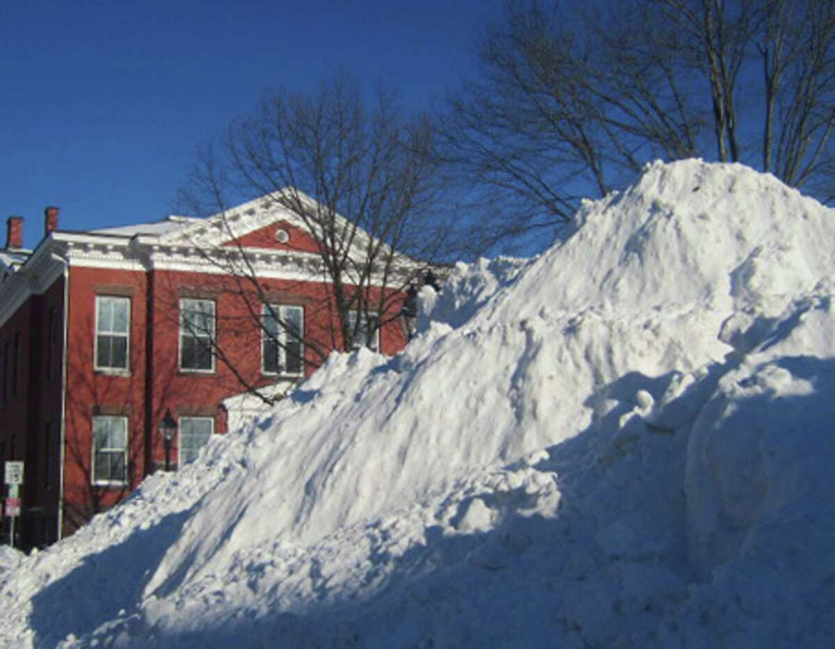 The plowed snow here might not really have been piled as high as the top of New Milford Town Hall, but it surely might have seemed so for those who ventured Feb. 9, 2013 to the village center during the waning hours of a weekend storm.