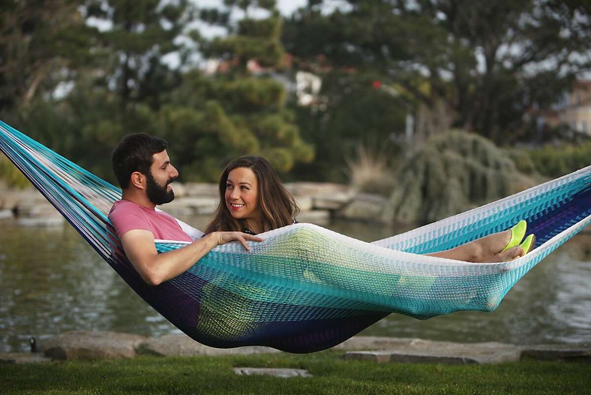 Yellow Leaf co-founder and chief relaxation officer Joe Demin (l to r) and co-founder and chief strategist of "psst...pass it on!" Rachel Connors pose for portraits with an Islamorada hammock on Tuesday, December 17, 2013 in San Francisco, Calif.
