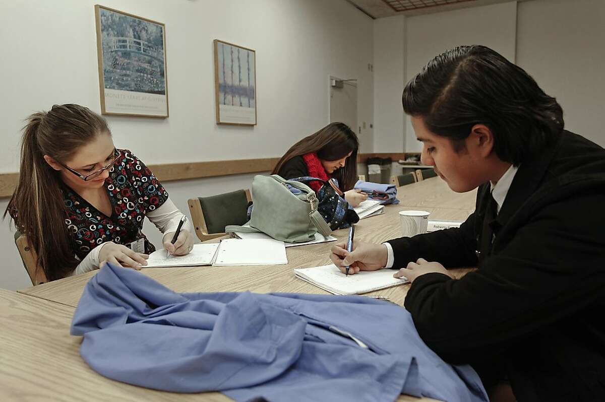 High school students MadisonBadger, Gabriela Ayala and Roberto Perez, on Thursday Dec. 19, 2013, log their experiences into a journal at the end of each visit to St. Rose Hospital in Hayward, Ca. More than ten years ago Dr. Tomas Magana was practicing medicine in Oakland and decided to start a program to give high school students from racially diverse, inner city and low-income households, a chance to intern at local hospitals. Faces for the Future tutors, mentors and trains high school students interested in a health care career.