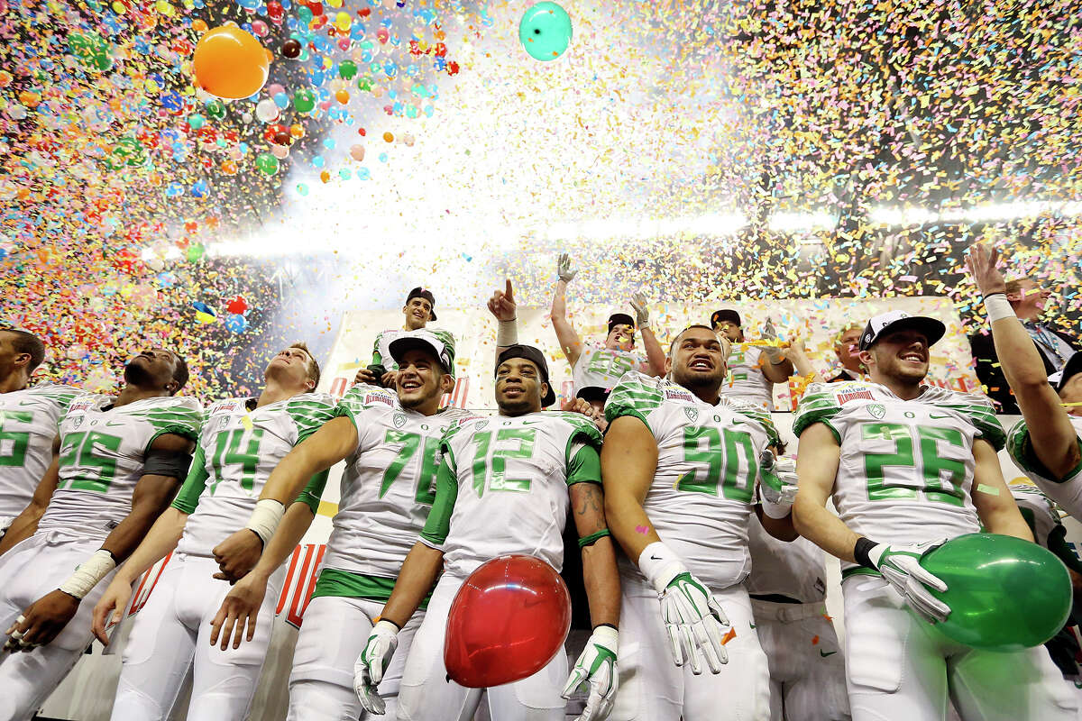 Members of the Oregon Ducks celebrate after the Valero Alamo Bowl with the Texas Longhorns Monday Dec. 30, 2013 at the Alamodome. Oregon won 30-7.