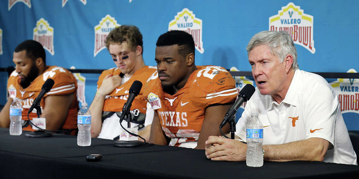 Texas Longhorns' Jackson Jeffcoat, (from left) Case McCoy, and Malcolm Brown listen to head coach Mack Brown speak during a press conference after the Valero Alamo Bowl with the Oregon Ducks Monday Dec. 30, 2013 at the Alamodome. Oregon won 30-7.