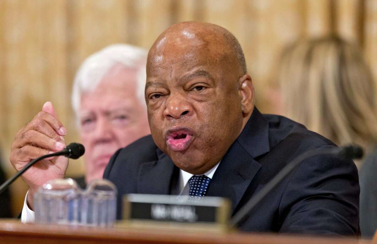 In this Oct. 29, 2013 file photo, House Ways and Means Committee member Rep. John Lewis, D-Ga. speaks during a hearing on Capitol Hill in Washington. Congress was to let a package of 55 popular tax breaks expire at the end of 2013, creating uncertainty - once again - for millions of individuals and businesses. The annual practice of letting these tax breaks expire is a symptom a divided, dysfunctional Congress that struggles to pass routine legislation, said Lewis, a senior Democrat on the tax-writing House Ways and Means Committee. (AP Photo/J. Scott Applewhite, File)