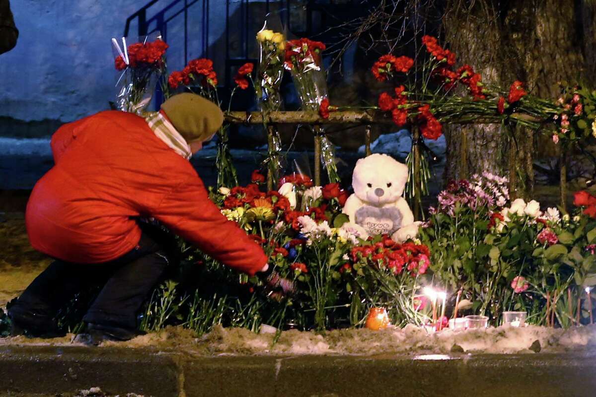A woman adds to a makeshift memorial to victims of a suicide bombing in Volgograd, as Russia beefed up security Tuesday at train stations and other facilities.