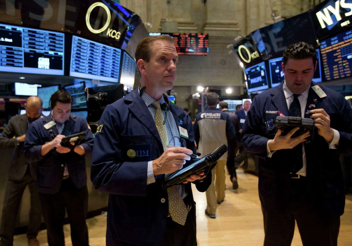 Traders work on the floor of the New York Stock Exchange Tuesday. The benchmark Standard & Poor's 500 stock index ended the year almost 30 percent higher than it began.