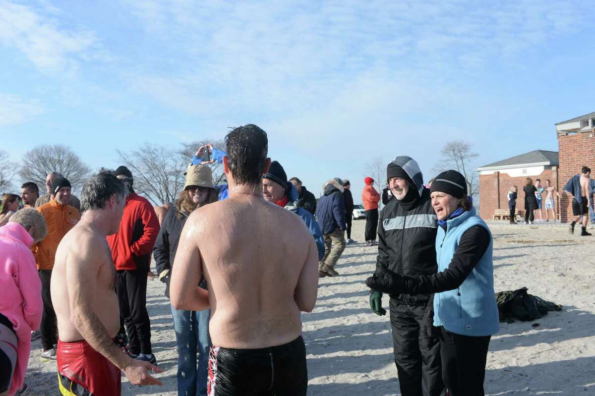 Team Mossman held their 11th annual polar plunge on New Year's Day at Compo Beach in Westport.  The plunge was scheduled for 10 a.m.  The air was brisk and we can only imagine what temperature the water was. All of the donations these divers collect benefit Save the Children.  Save the Children is a charity that helps improve the lives of impoverished children in more than 120 countries around the world.  